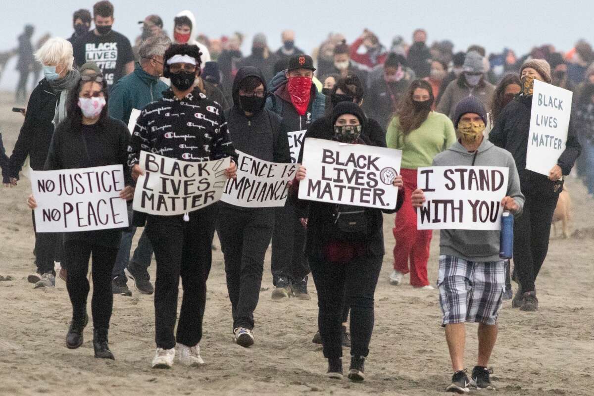 No one was marching. So Devin Stocks, Beth Chiarelli, and Kevin and Emma Frederick decided to lead the way, lifting signs into the air that read “Black Lives Matter” and “I Stand With You” as they silently made their way down the beach. When they looked back, dozens of people were following them, their own signs held high.