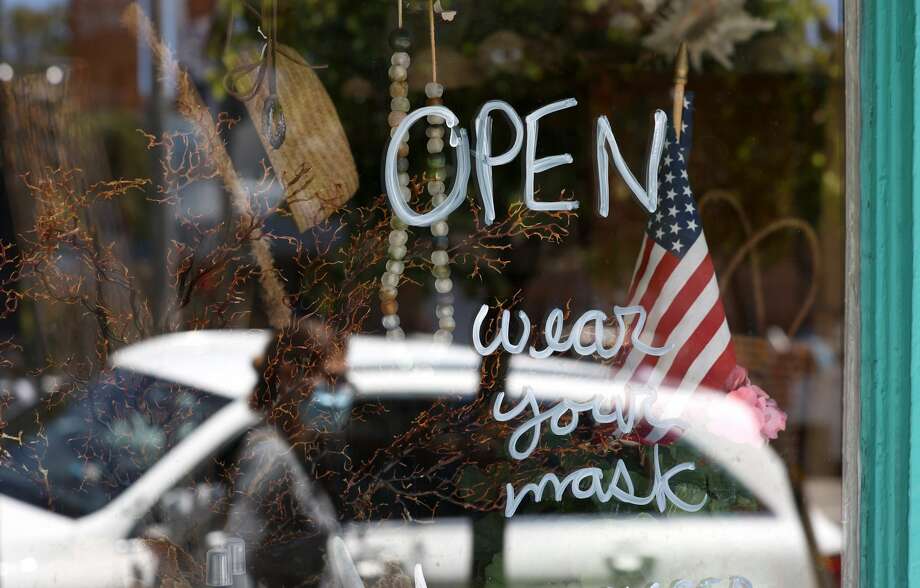 A pedestrian walks by a retail store that has reopened on June 16, 2020 in San Francisco, California. Photo: Justin Sullivan/Getty Images / 2020 Getty Images