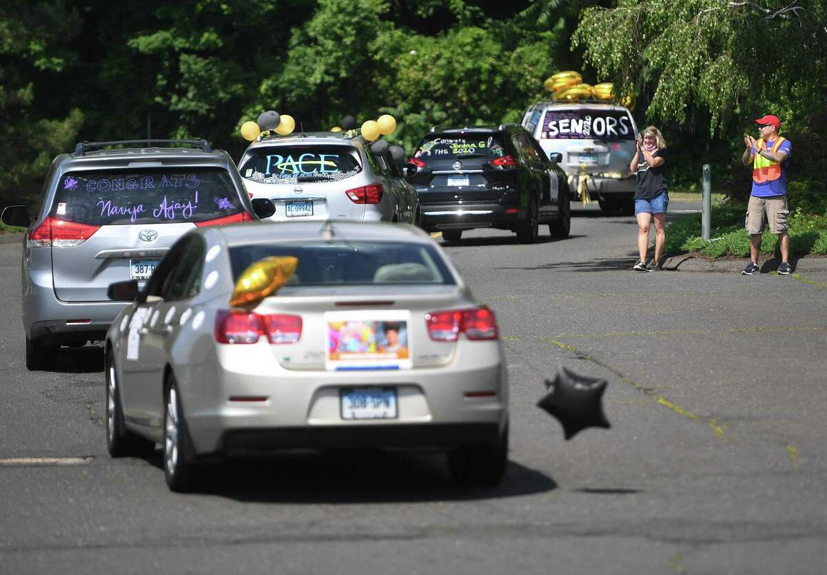 Trumbull High School grads participate in the Trumbull Eagles FlyThru street procession from the Westfield Trumbull Mall to Trumbull High School in Trumbull, Conn. on Sunday, June 21, 2020.