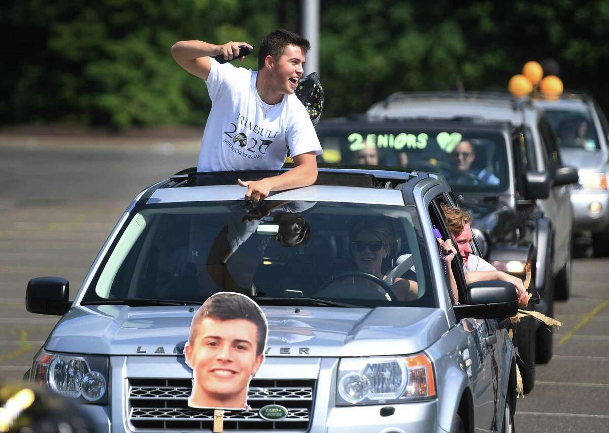 Trumbull High School grads participate in the Trumbull Eagles FlyThru street procession from the Westfield Trumbull Mall to Trumbull High School in Trumbull, Conn. on Sunday, June 21, 2020.