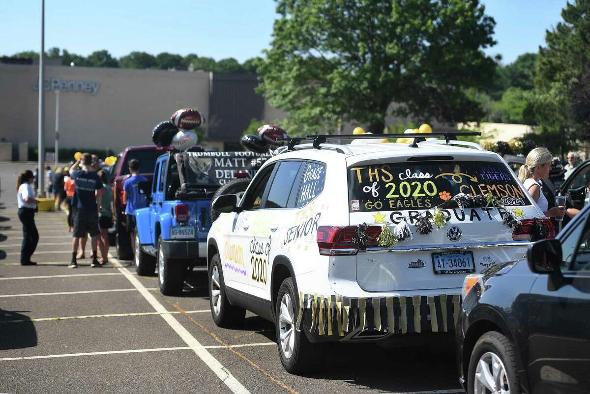 Trumbull High School grads lines up their decorated cars for the Trumbull Eagles FlyThru street procession from the Westfield Trumbull Mall to Trumbull High School in Trumbull, Conn. on Sunday, June 21, 2020.