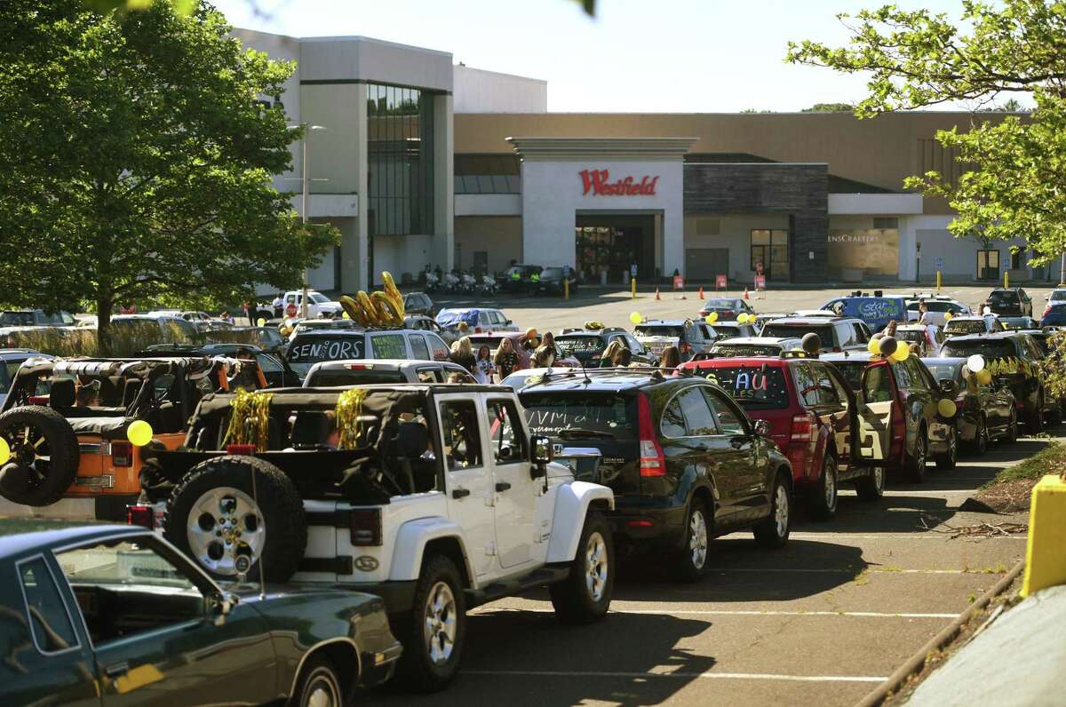 Trumbull High School grads lines up their decorated cars for the Trumbull Eagles FlyThru street procession from the Westfield Trumbull Mall to Trumbull High School in Trumbull, Conn. on Sunday, June 21, 2020.