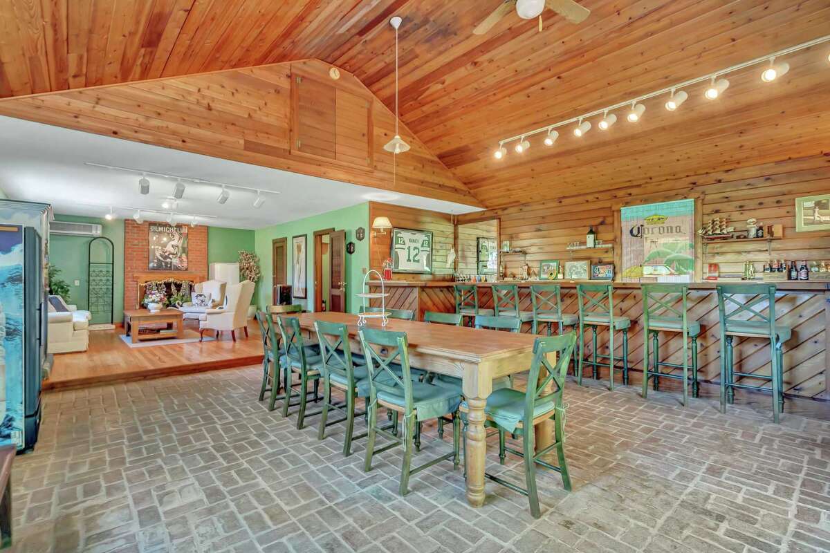 In the pool house there is a long service bar that is perfecet for entertaining. Because this residential compound is surrounded by Aspetuck Land Trust protected open space, its privacy is assured. Nothing will be built on the Randall’s Farm Preserve, a former dairy farm operated by the Randall family, now “a scenic 34-acre expanse of meadows, fields, forested wetlands and hardwood forest … one of the last great old farm fields and few areas remaining in historic long lots,” according to the land trust website. Homeowners can walk to this preserve, meander on its groomed trails passed a pond and through its wildflower meadows, using a special app, if they choose, to document local wildlife and upload it to the website for the land trust. It has teamed up with the non-profit Citizen Science’s iNaturalist program allowing people to share their wildlife sightings and scientific observations via the app. It’s like having a nature classroom in the backyard.