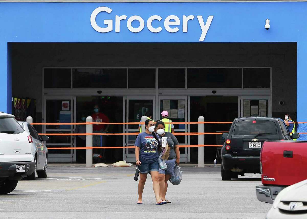 Shoppers leave a Walmart as the latest mask order takes effect Monday, June 22, 2020.