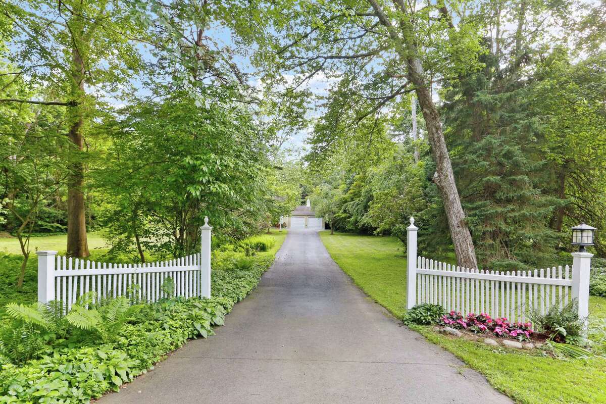 White picket fences mark the entrance to this Connecticut property. White picket fences A white picket fence is the quintessential mark of suburbia - especially in New England, Schwartz said. They also add to a home's curb appeal, which can potentially increase the property value.