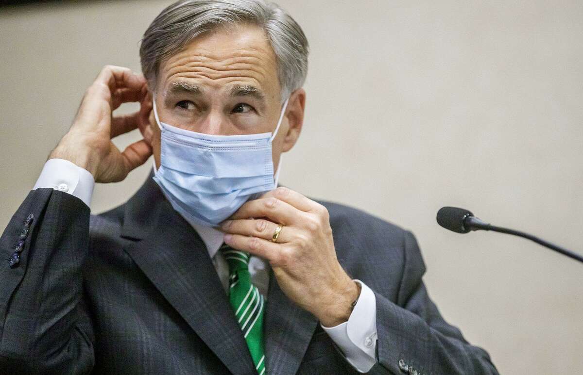 Texas Gov. Greg Abbott adjusts his mask during a recent coronavirus updates.