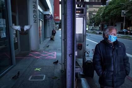 Juventino Barojas at the bus stop where he sleeps on Mission Street in San Francisco.