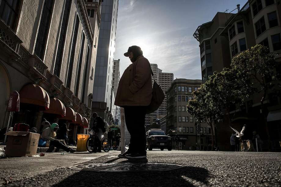 Michael Halpin, 69, stands on Ellis Street hoping to speak to someone about getting a hotel room at Glide Memorial Church in San Francisco. Calif., on Friday, May 22, 2020. Homeless senior citizens are having greater level of risk living on the streets of the city during the coronavirus pandemic. Photo: Carlos Avila Gonzalez / The Chronicle