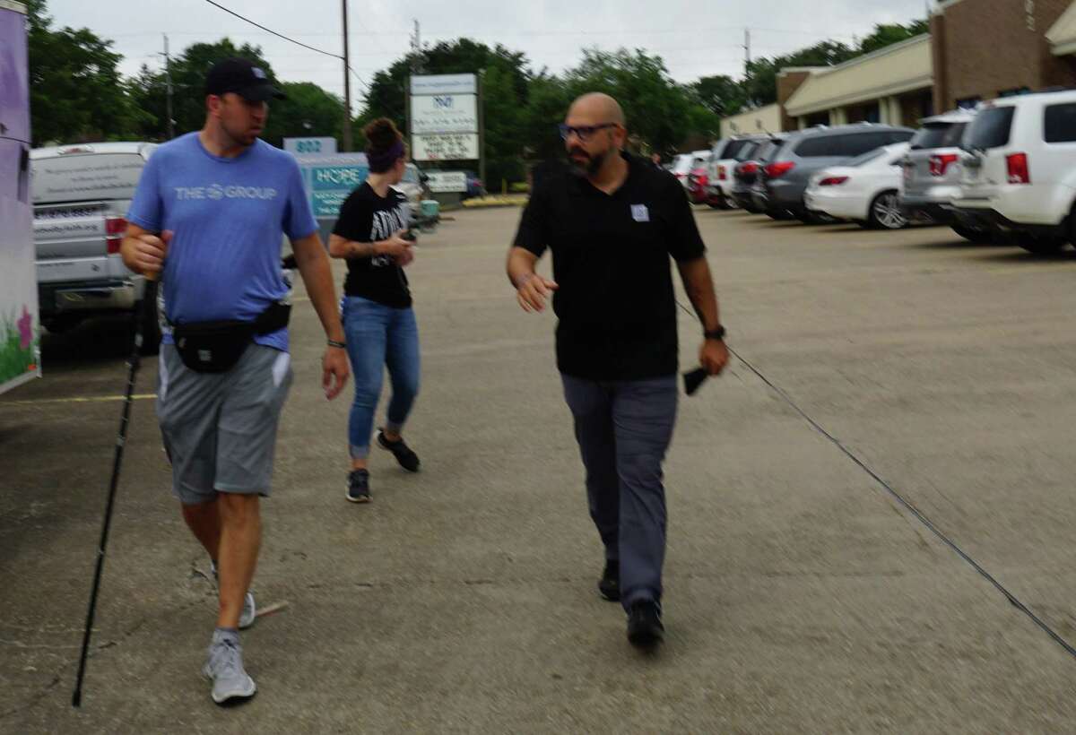 Titus Benton, left, founder of The 25 Group, starts his 22-mile walk from Katy to Stafford on Monday, June 22, to raise funds in partnership with Attack Poverty for a project in East Asia that would give roughly 200 families clean water. Attack Poverty CEO Brandon Baca, right, accompanies Benton for the first mile.