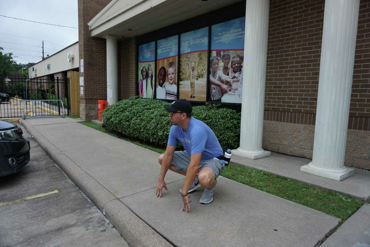 Titus Benton, founder of The 25 Group, stretches on Monday, June 22, at their headquarters in Katy before leaving for a 22-mile walk to raise $22,000 for a project with Attack Poverty that would give clean water to a community in East Asia.