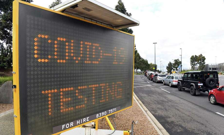 A long line of cars waits at a drive-through COVID-19 testing site Photo: Getty Images / AFP or licensors