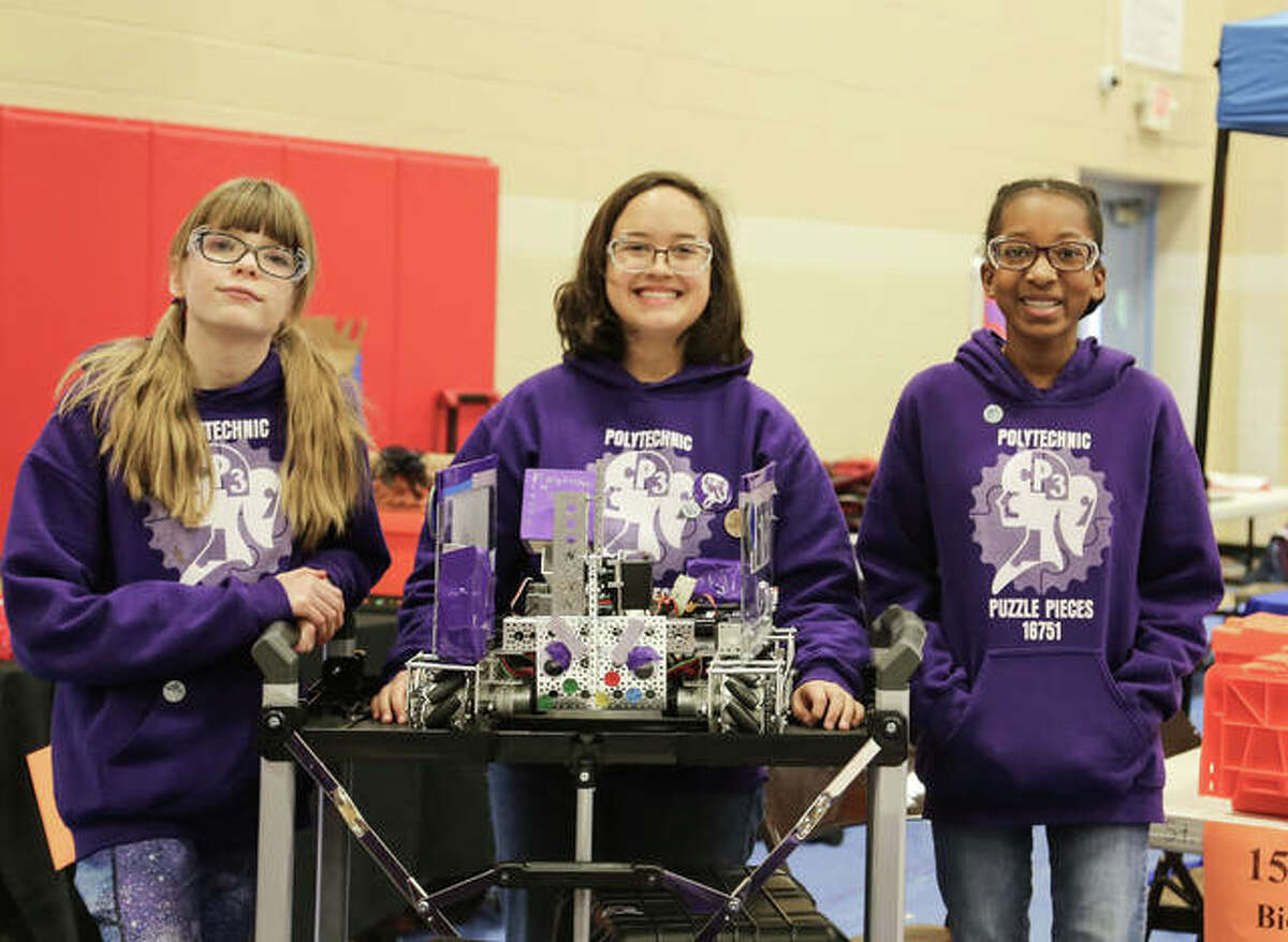 Girl Scouts display a robot they designed, built and programmed for competition in FIRST Tech Challenge robotics league.