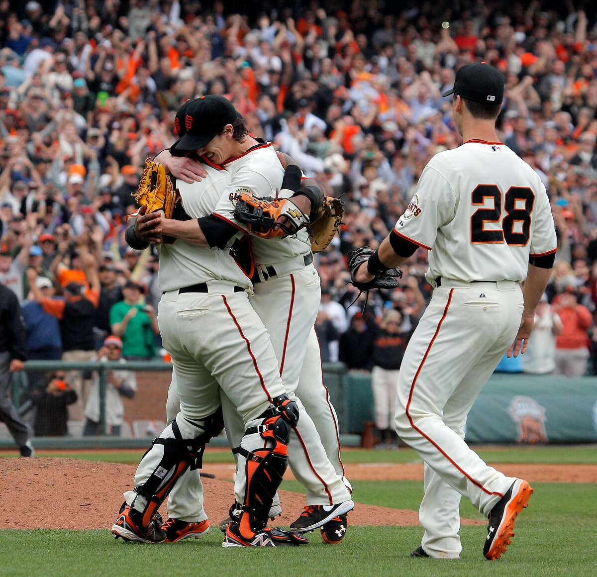 Pitcher Tim Lincecum, center, is mobbed by teammates after he pitched a no hitter as the San Francisco Giants played the San Diego Padres at AT&T Park in San Francisco, Calif., on Wednesday, June 25, 2014, defeating the Padres 4-0.