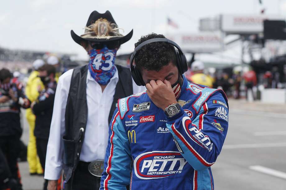 Bubba Wallace wipes away tears at the show of support by team owner Richard Petty (left) and other NASCAR drivers Monday prior to the start of the NASCAR Cup Series race at the Talladega Superspeedway in Talladega, Ala. Photo: John Bazemore / Associated Press