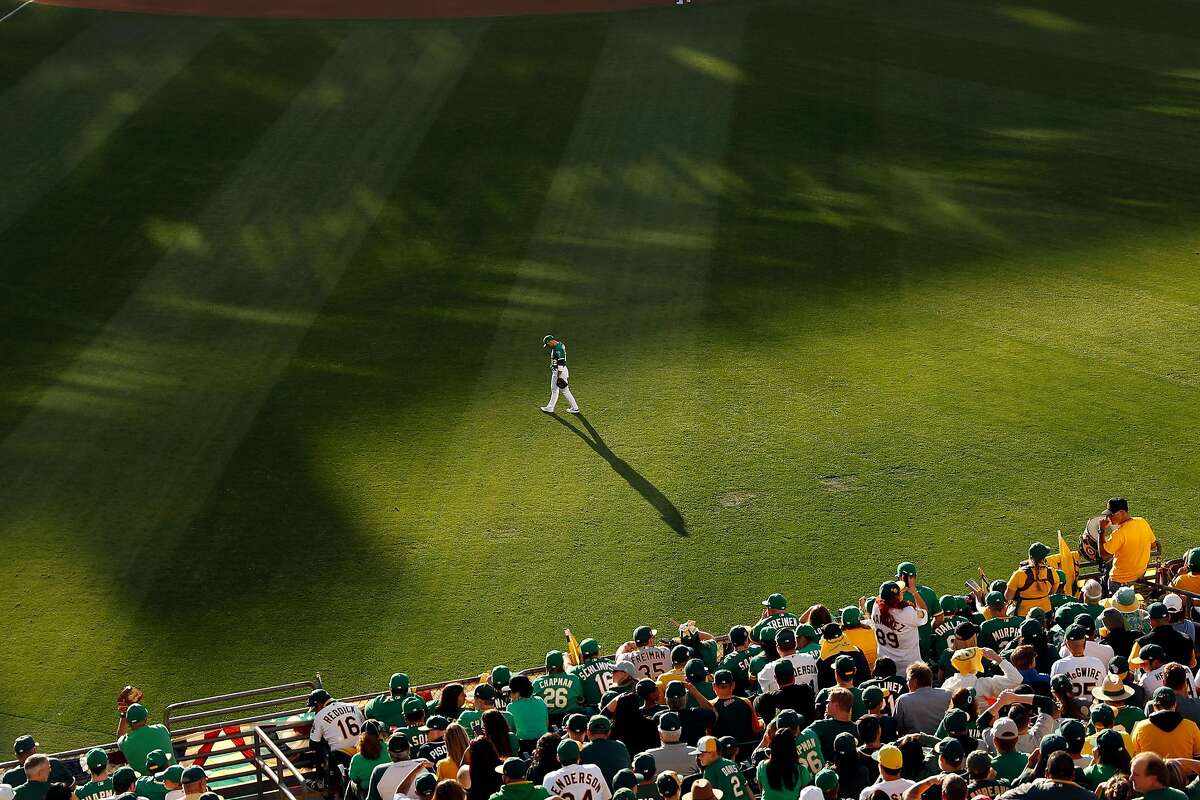 Oakland Athletics' left fielder Ramon Laureano looks down in 3rd inning as Tampa Bay Rays score their fourth run in American League Wild Card game at Oakland Coliseum in Oakland, Calif., on Wednesday, October 2, 2019.