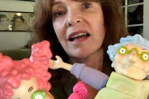Actress Melanie Chartoff, 71, of Los Angeles, holds two Rugrats characters that she helped make famous with her voice, Didi Pickles on the left and Didi's mother, Minka, on the right.