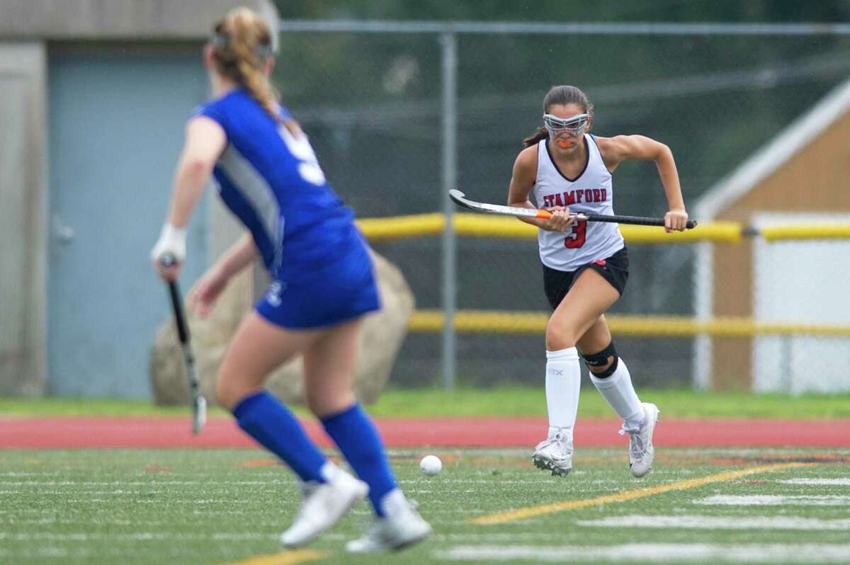 Stamford High School junior Devon Yaghmaie sprints upfield with the ball during a varsity field hockey game against Fairfield Ludlowe High School at Boyle Stadium in Stamford, Conn. on Monday, Sept. 17, 2018.