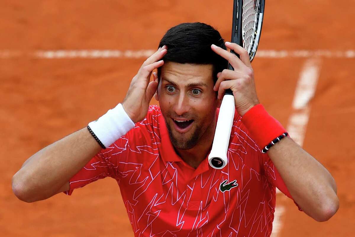 Serbia's Novak Djokovic reacts as he takes part in tennis match during a charity exhibition hosted by him, in Belgrade on June 12, 2020. - Novak Djokovic has also tested positive for coronavirus on June 23, 2020 along with Grigor Dimitrov, Borna Coric and Viktor Troicki, after taking part in an exhibition tennis tournament in the Balkans featuring world number one Novak Djokovic, raising questions over the sport's planned return in August. (Photo by Andrej ISAKOVIC / AFP) (Photo by ANDREJ ISAKOVIC/AFP via Getty Images)
