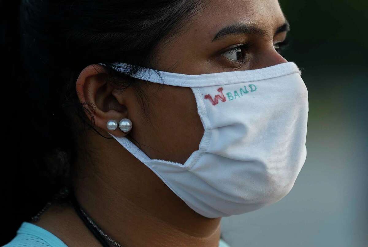 Mahika Peri wears a face mask during marching band practice at The Woodlands High School, Wednesday, June 17, 2020, in The Woodlands. Students were able to participate under social distancing guidelines and with regular disinfecting of equipment, according to regulations set by the University Interscholastic League.