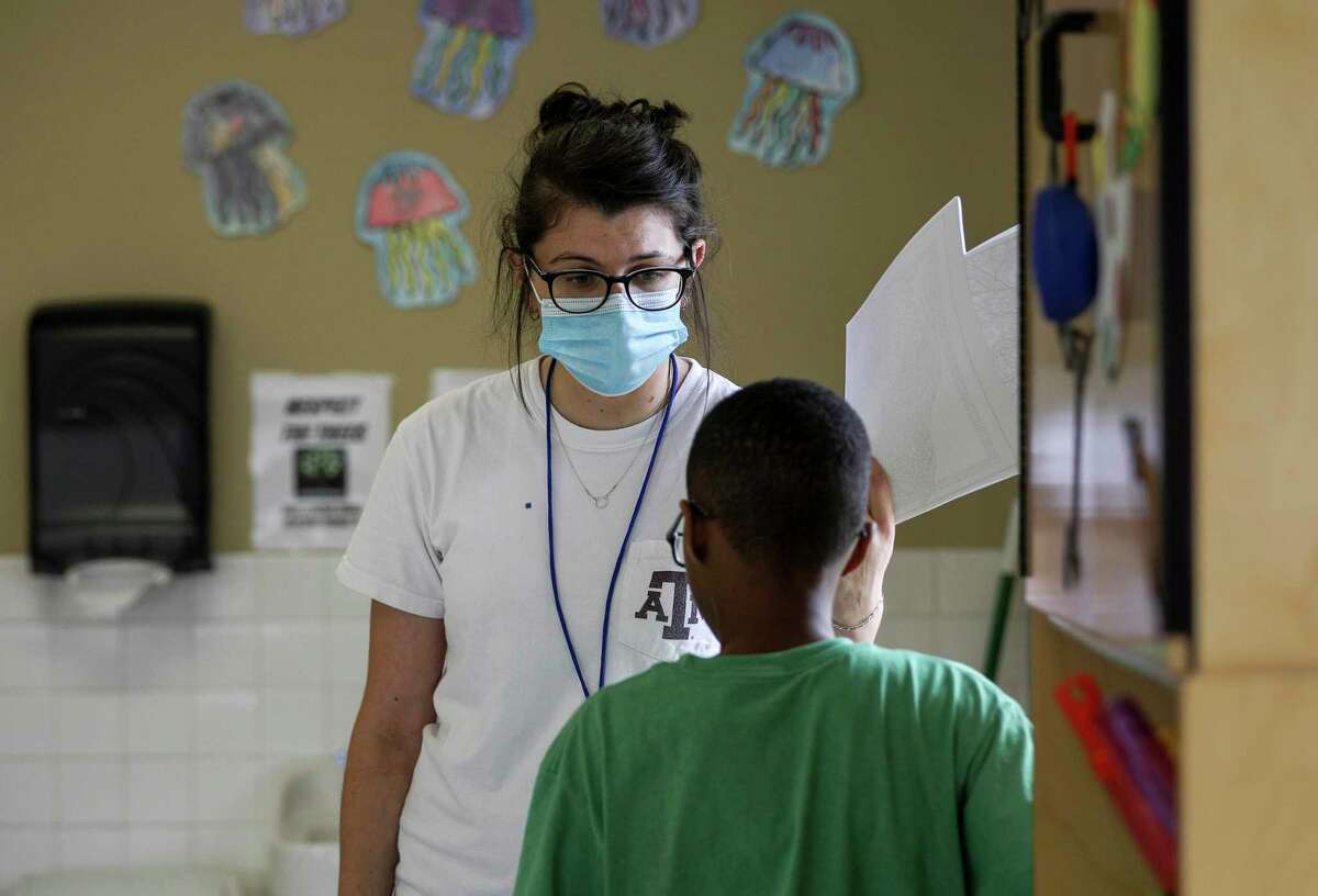 Julia Revelli, a lead teacher for the after school program at Little Academy of Humble, talks to a student while cleaning her classroom Tuesday, June 23, 2020, at the school in Humble. Revelli's students range in age from 5 years old to 10 years old.