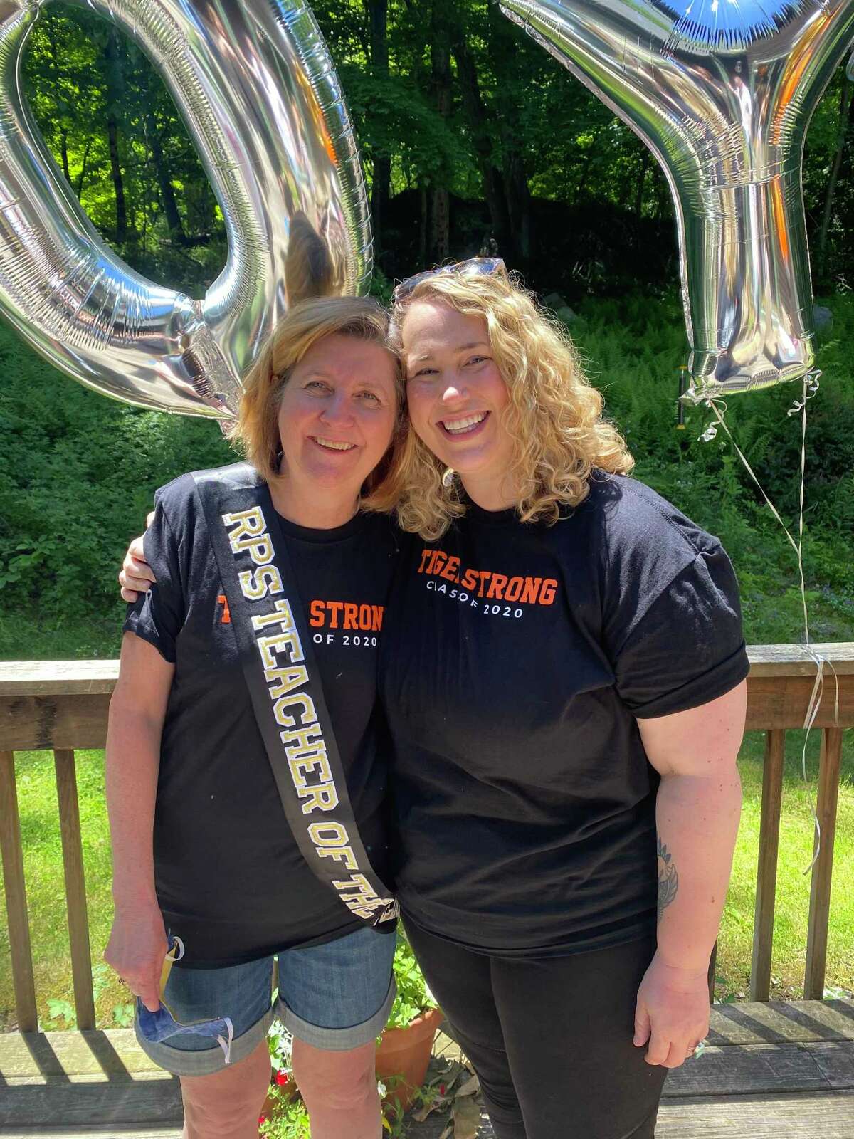 Lori Peck (left), a family and consumer science teacher at Ridgefield High School, was chosen as the Ridgefield Public Schools' Teacher of the Year. Fellow RHS teacher Jenn DeJulio (right) helped arrange a surprise award ceremony in the backyard of Peck's home in Newtown.