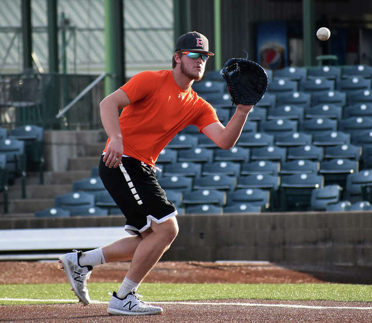 Edwardsville’s Gavin Reames fields a ground ball at first base during an infield drill at Tuesday’s practice inside GCS Stadium in Sauget.