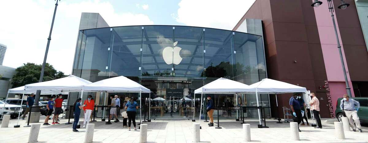 Apple set up tents to screen customers, as customers lined up at Highland Village Apple Store, in Houston, Wednesday, May 27, 2020, as Apple opened up for the first time since the pandemic. Due to deteriorating conditions in the region, Houston-area stores are being reclosed temporarily.