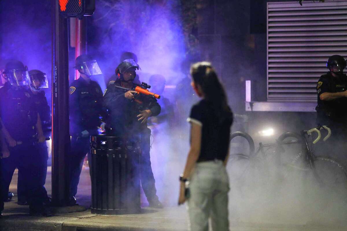 Protestors and law enforcement face off during ongoing demonstrations for George Floyd, a Houston native who died in custody of the Minneapolis police earlier this week, in downtown Houston on Saturday, May 30, 2020.