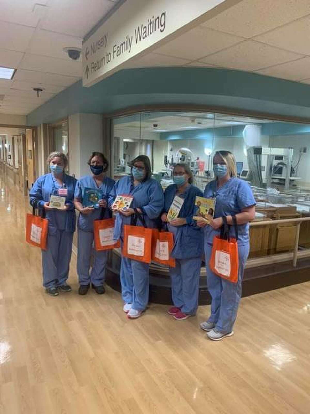 Alton Memorial Hospital staff display the Books for Newborns donations recently received for parents and big brothers and sisters.