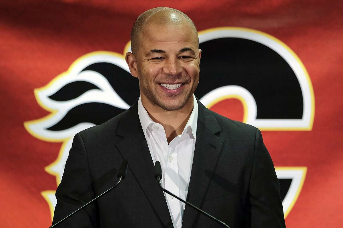 FILE - In this July 30, 2018, file photo, former Calgary Flames hockey team captain Jarome Iginla announces his retirement from the NHL at a news conference in Calgary, Alberta. Iginla, the first Black player to lead the NHL in points and goals and to win an Olympic gold medal, is expected to headline the Hockey Hall of Fame's 2020 induction class, to be announced Wednesday, June 24, 2020. (Jeff McIntosh/The Canadian Press via AP, File)
