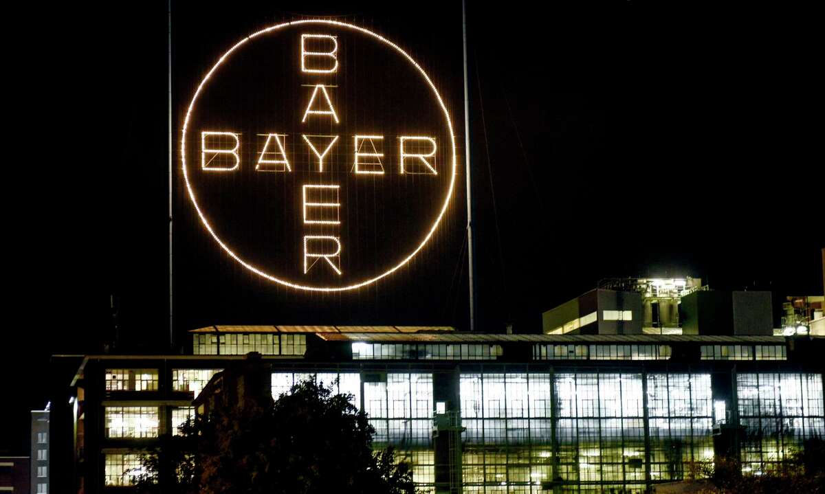 FILE - In this Aug. 9, 2019, file photo, the Bayer logo shines at night at the main chemical plant of German Bayer AG in Leverkusen, Germany. The German pharmaceutical company announced Wednesday, June 24, 2020, itas paying up to $10.9 billion to settle a lawsuit over subsidiary Monsantoas weedkiller Roundup, which has faced numerous lawsuits over claims it causes cancer. (AP Photo/Martin Meissner, File)