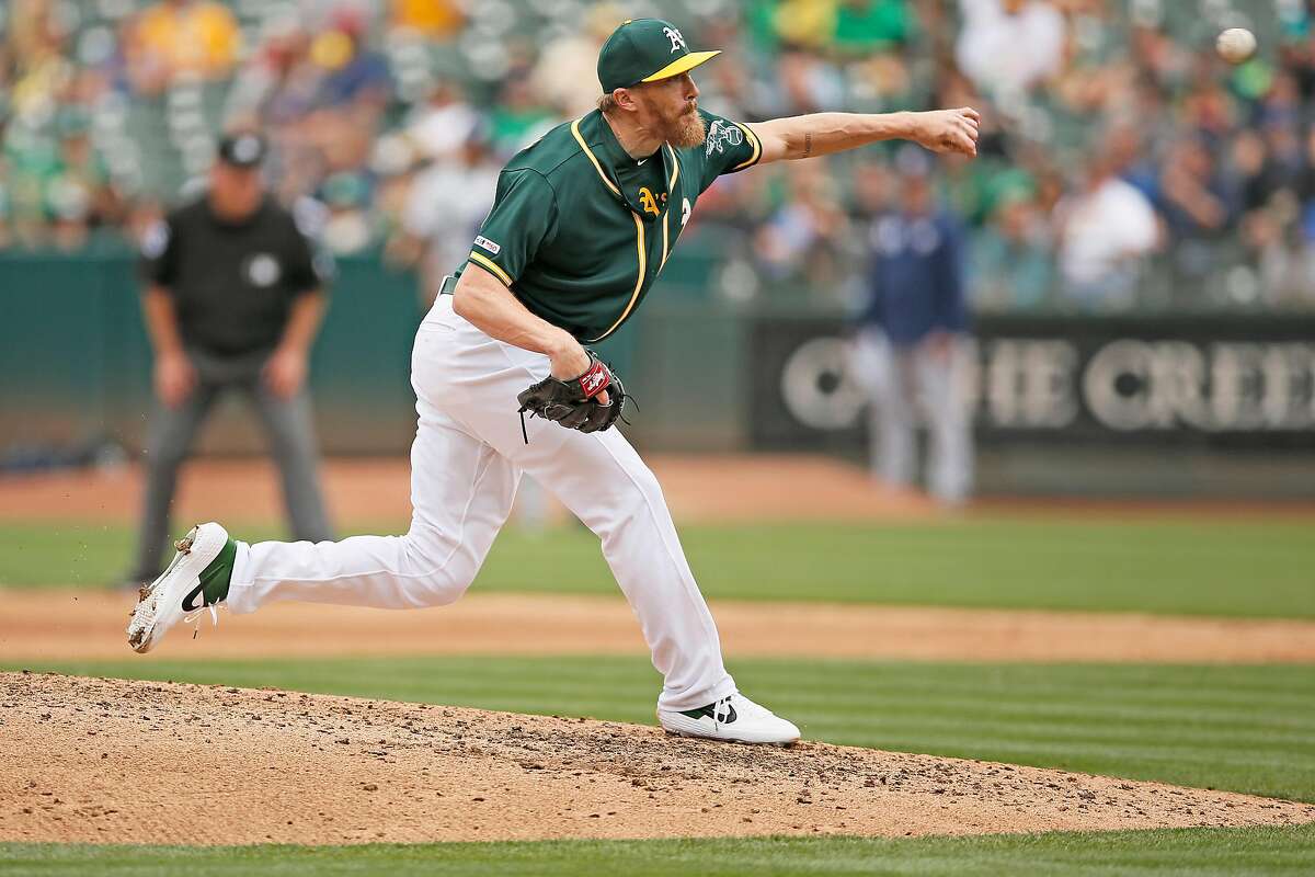 Oakland Athletics relief pitcher Jake Diekman throws during the seventh inning of an MLB game against the Milwaukee Brewers at the Oakland-Alameda County Coliseum on Aug. 1, 2019, in Oakland, Calif.