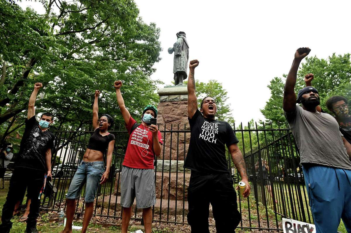 Protesters spoke out in front of the statue of Columbus at Wooster Square on June 24.