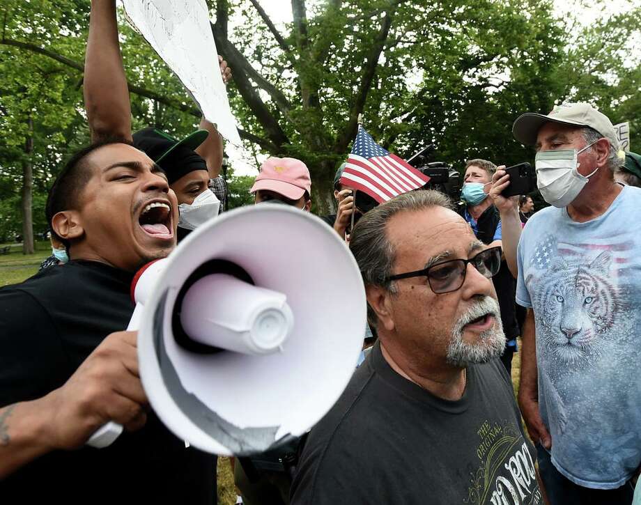 New Haven, Connecticut - Wednesday, June 24, 2020: The statue of Christopher Columbus was removed from Wooster Square park Wednesday afternoon hours after a skirmish erupted early in the morning between people of opposing viewpoints. Later, with a large police presence, hundreds of people gathered to watch the removal of the monument and demonstrate against racism. The statue of Christopher Columbus was removed from Wooster Square Park has been removed as of this afternoon. The statue will remain in custody with the City, ahead of planning for it to reside at the Knights of Columbus Museum. The statue holds deep ties to the Italian-American community, as it was first erected in 1892, and later recast in bronze in 1955. Prior to the statue’s removal this morning, protesters for and against the statute removal demonstrated, and some altercations broke out. Photo: Peter Hvizdak / Hearst Connecticut Media / New Haven Register