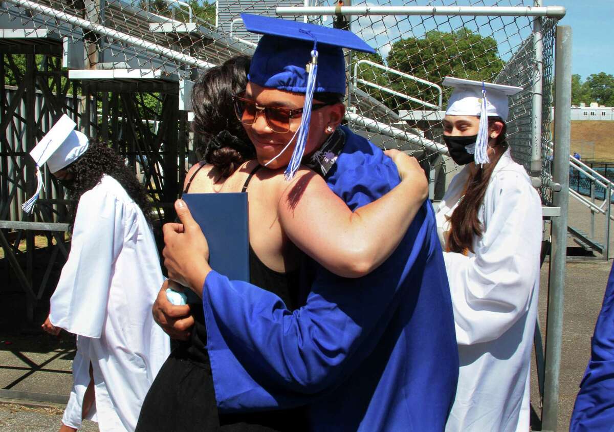 Graduate Thaylan Terry hugs his teacher Jennifer Berkowitz on Wednesday.
