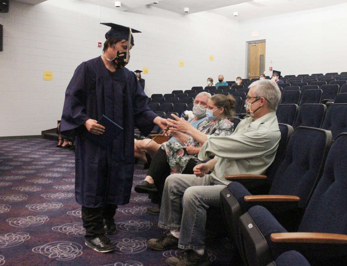 Despite having to maintain safe social distancing and wear face masks to prevent the spread of the coronavirus, members of the Chippewa Hills Mosaic graduating class were all smiles as they collected their diplomas from the auditorium stage Wednesday evening.