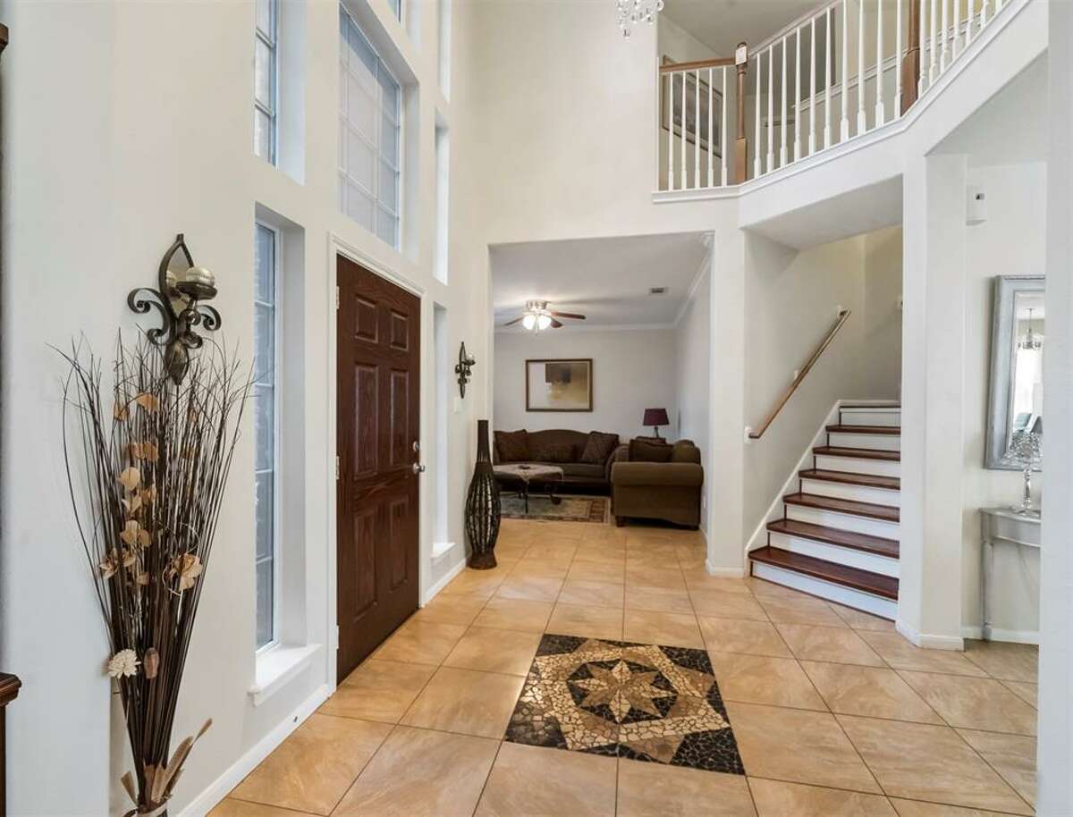 Its foyer welcomes guests into a two-story grand room.