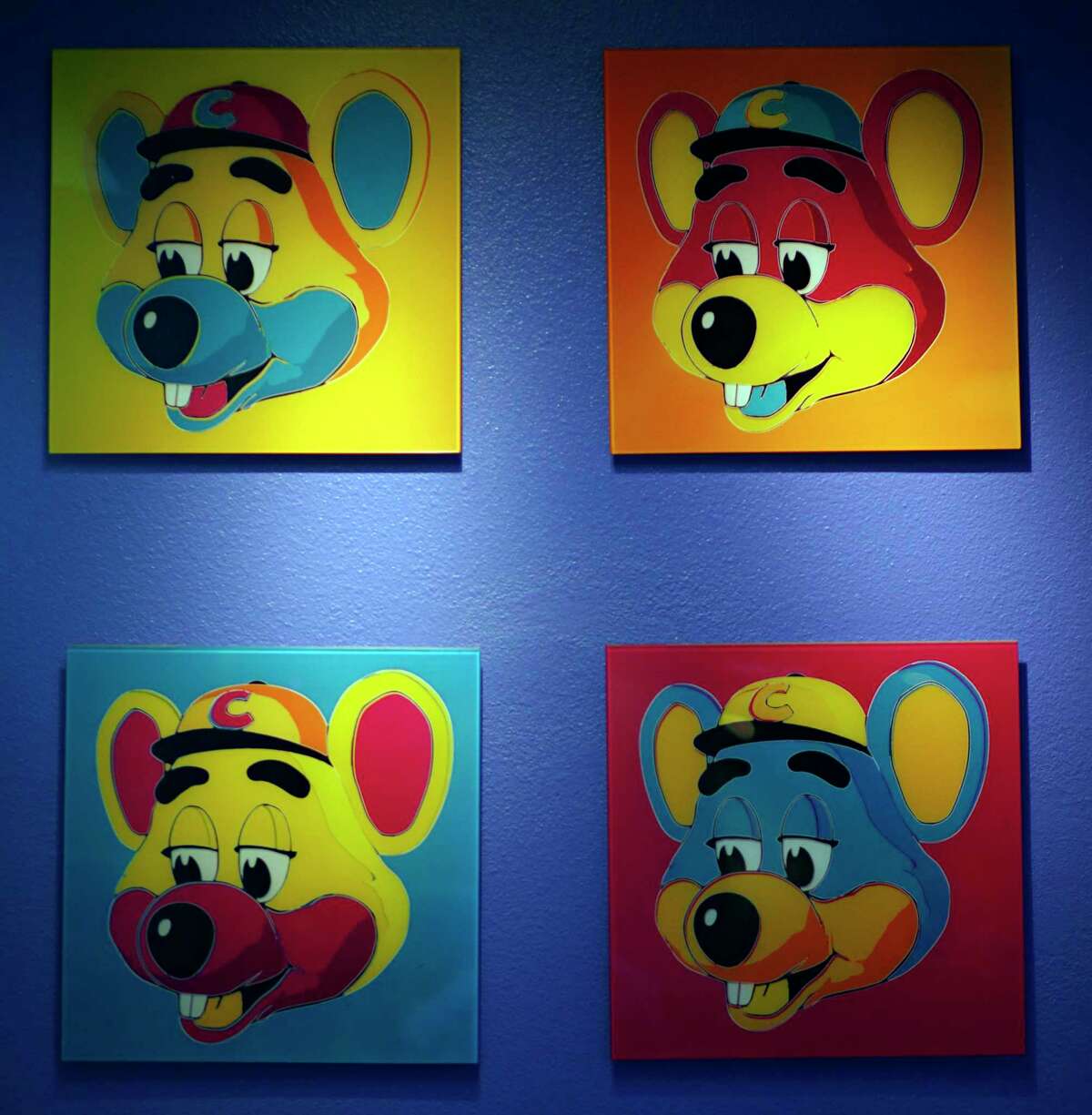 FILE - This Jan. 16, 2014 file photo shows paintings hanging on a wall at Chuck E. Cheese's in Dallas. Chuck E. Cheese pizzeria, that Mecca of fun for children but the bane of many parents, is filing for bankruptcy protection. CEC Entertainment Inc. said Thursday, Jan. 25, 2020, it was filing for voluntary protection under Chapter 11 ain order to overcome the financial strain resulting from prolonged, COVID-19 related venue closures.a (G.J. McCarthy/The Dallas Morning News via AP)
