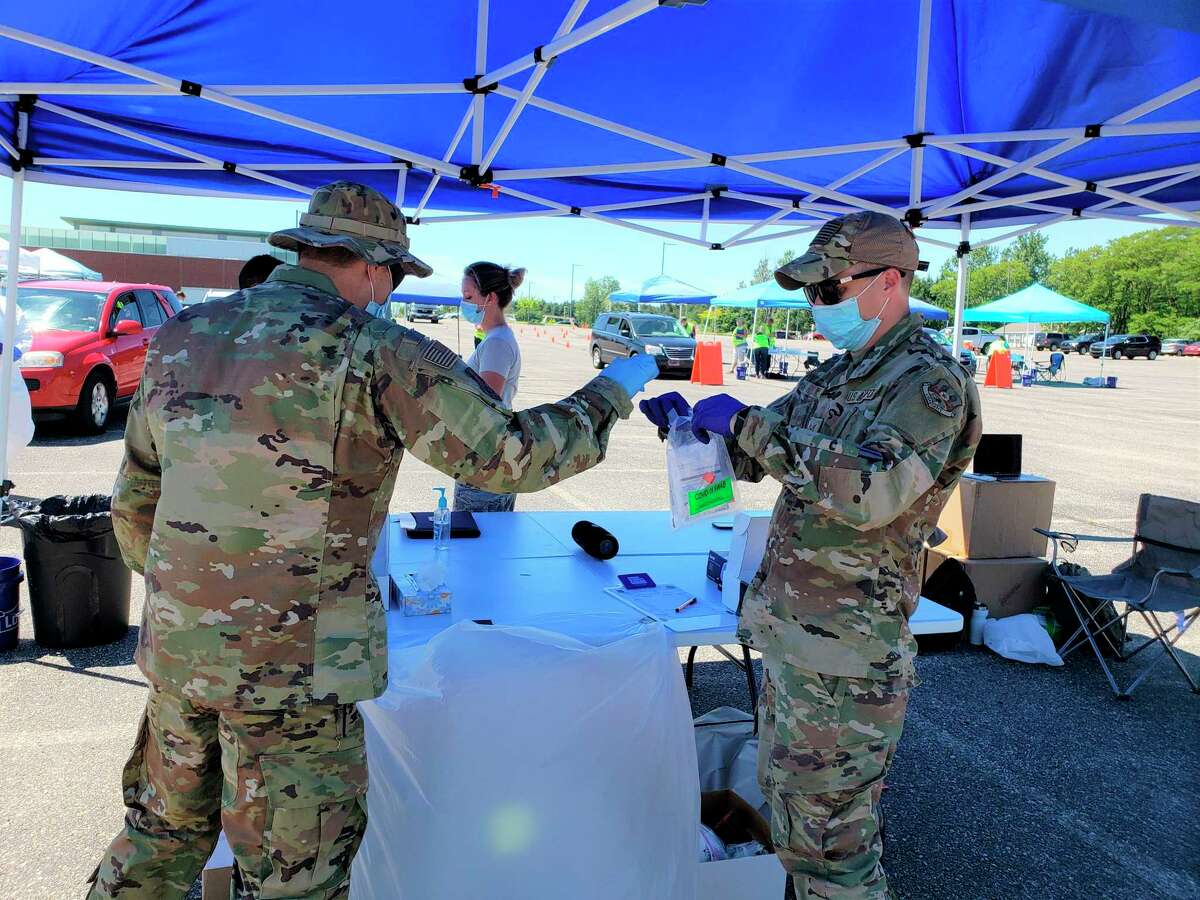 Members of the National Guard took nasopharyngeal swab samples at the screening event at the Manistee High School parking lot Thursday. The swabs were labeled, packed and were set to be sent to Bio Reference Laboratories for processing. (Arielle Breen/News Advocate)