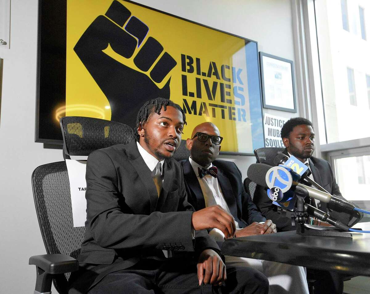 Tarae Frazier of Stamford left, and his cousin Tyshawn Frazier of Norwalk, speak with the media at their attorney's, Darnell Crosland, center, office on June 25, 2020 in Stamford, Connecticut. The Frazier's, along with other individuals were allegedly accosted by Steven Dudek at the Cove Island Marina loading ramp on Saturday. The incident was captured on video and is being investigated by the Stamford Police.