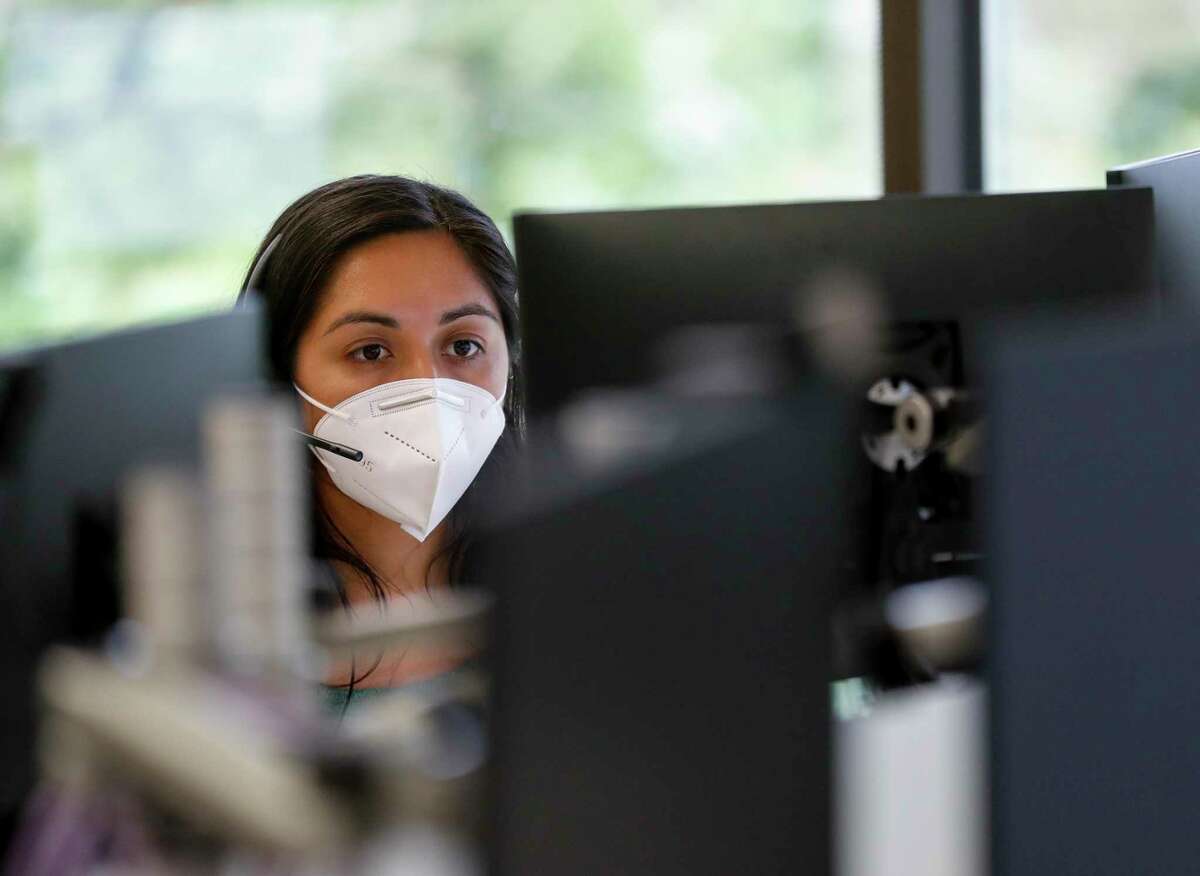 Alejandra Camarillo works on cases at Harris County Health Department. The agency launched online tracing last week.