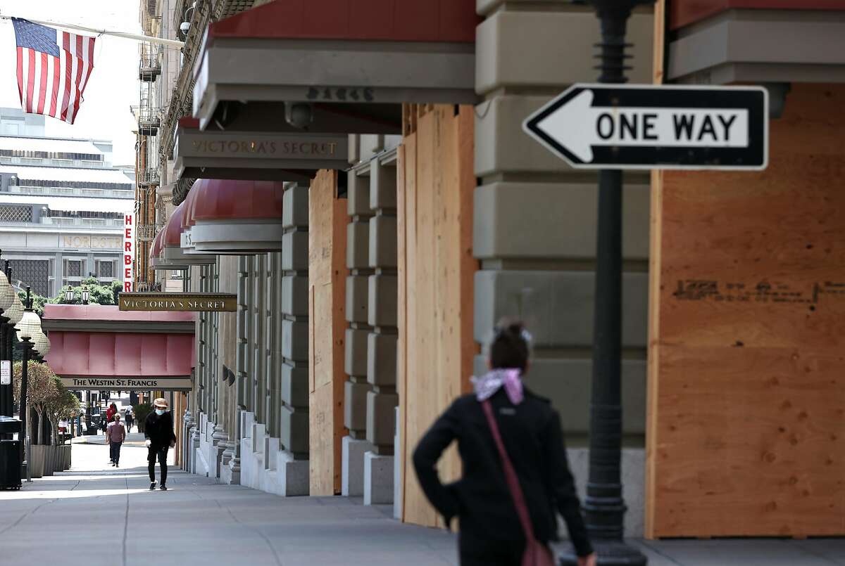 SAN FRANCISCO, CALIFORNIA - JUNE 11: Pedestrians walk by boarded up businesses on June 11, 2020 in San Francisco, California. Economic worries due to the coronavirus COVID-19 pandemic continue as an additional 1.5 million people filed for first-time unemployment benefits in the past week. The Dow Jones Industrial average plunged over 1,800 points on the news. (Photo by Justin Sullivan/Getty Images)