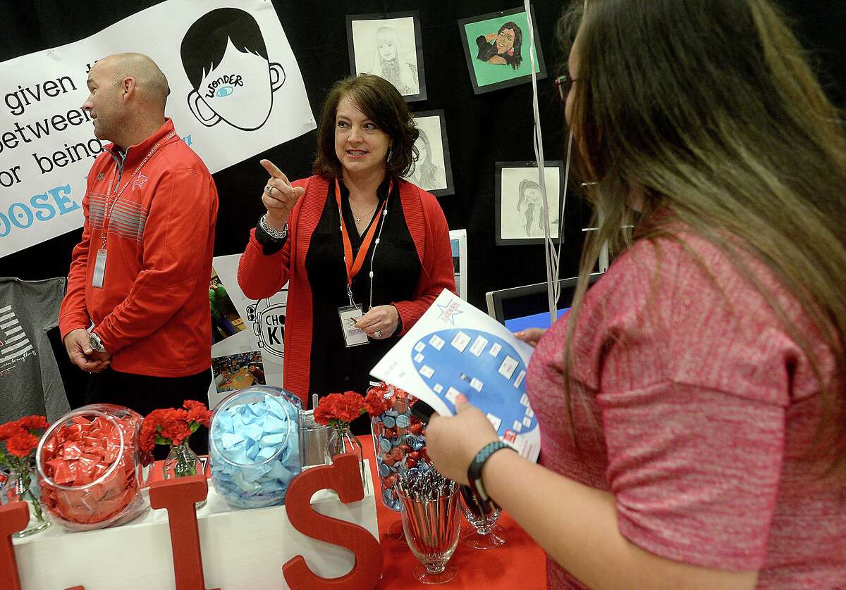 Lumberton Intermediate principal Paige Wing talks with a prospective job candidate as she and assistant principal Mike Tarver man their booth during the Lumberton ISD's first job fair, held Thursday at the Performing Arts Center. The district has over a dozen openings for various positions district-wide for the 2019 - 20 school year, including teaching, nutritional services, bus drivers, aides and administrative work. They decided to host a job fair so that interested applicants could find the range of openings available all in one spot. Photo taken Thursday, April 11, 2019 Kim Brent/The Enterprise