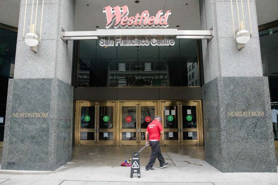 An employee cleans the entrance of the Westfield San Francisco Centre in San Francisco Calif. on June 26,2020. Photo: Douglas Zimmerman/SFGATE / SFGATE