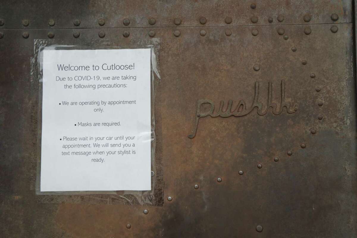 A sign on the front door of Cutloose, 1711 Westheimer Rd., Friday, June 26, 2020, in Houston.