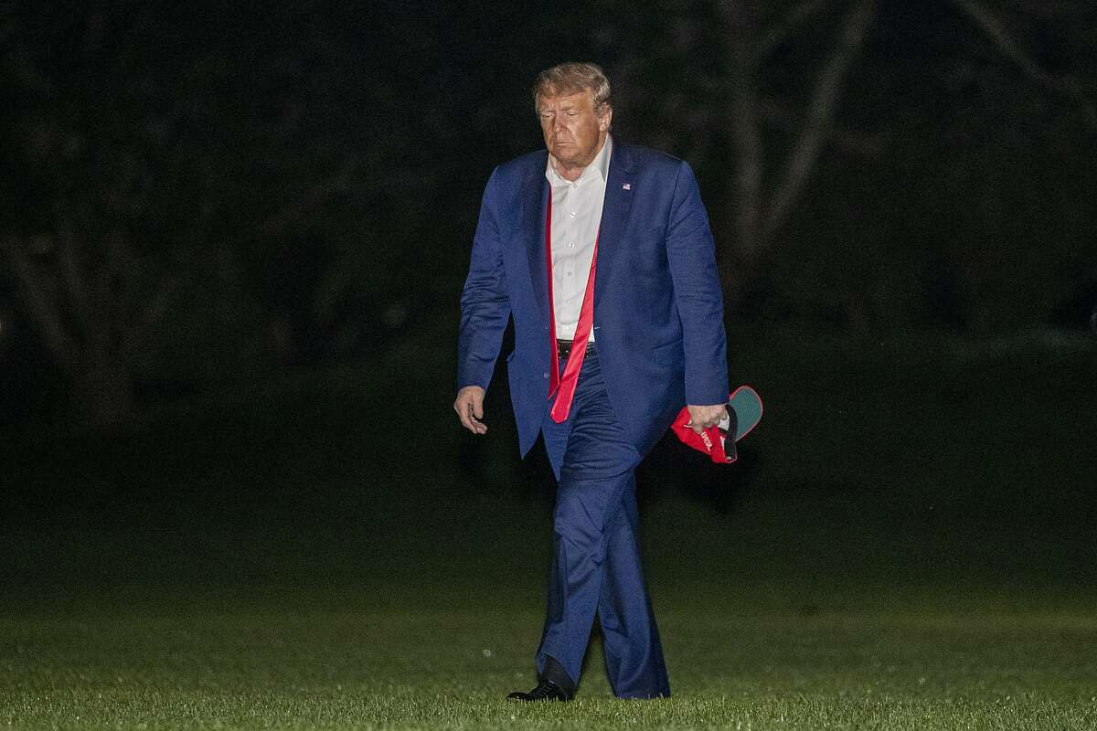 President Donald Trump walks on the South Lawn of the White House in Washington, early Sunday, June 21, 2020, after stepping off Marine One as he returns from a campaign rally in Tulsa, Okla. (AP Photo/Patrick Semansky)