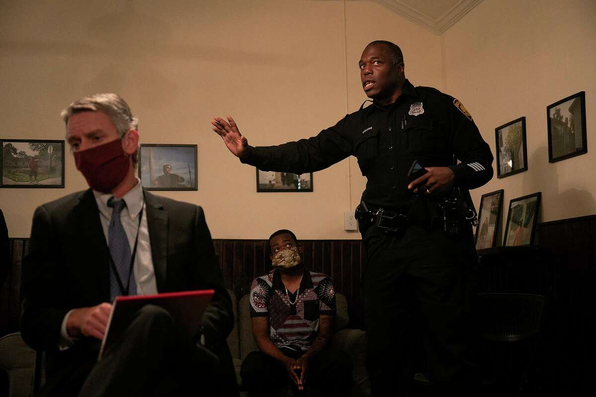 SAPD Officer Richard Odoms, right, talks about traffic stop procedures during a town hall meeting on "Criminal Justice Reform" and "Policing in our communities moving forward" in San Antonio on Wednesday, June 24, 2020. The town hall was the third meeting on the topic. At left is Christian Henricksen, Chief of Litigation at the Bexar County District Attorney's Office, and center is SAPD Officer Levon Harrison.