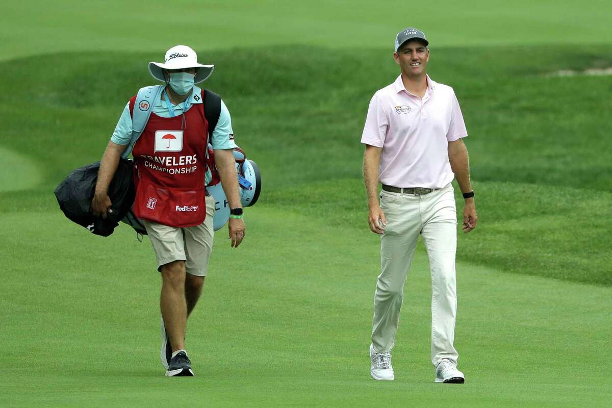 Brendon Todd, right, walks with his caddie Nick Jones as they approach the 15th green during the third round of the Travelers Championship golf tournament at TPC River Highlands, Saturday, June 27, 2020, in Cromwell, Conn. (AP Photo/Frank Franklin II)