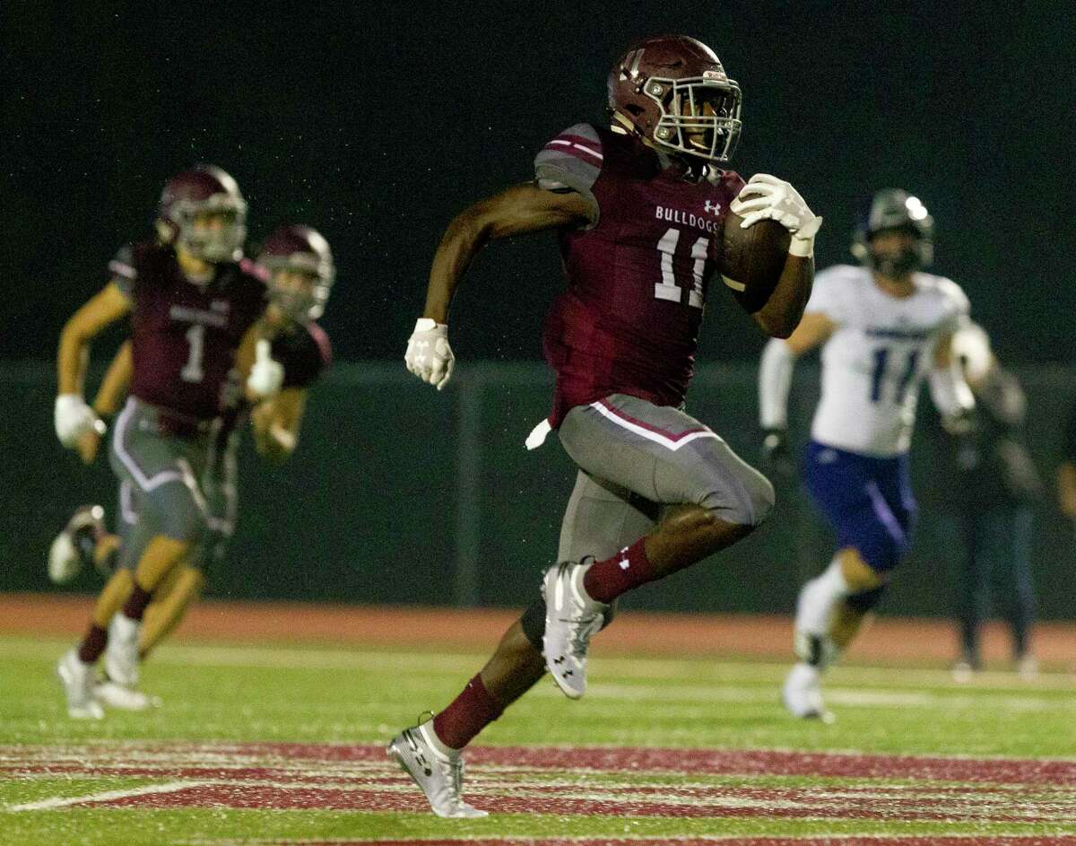 Magnolia running back Darren Battle (11) runs for a 43-yard gain during the first quarter of a District 8-5A high school football game at Bulldog Stadium, Friday, Oct. 19, 2018, in Magnolia.