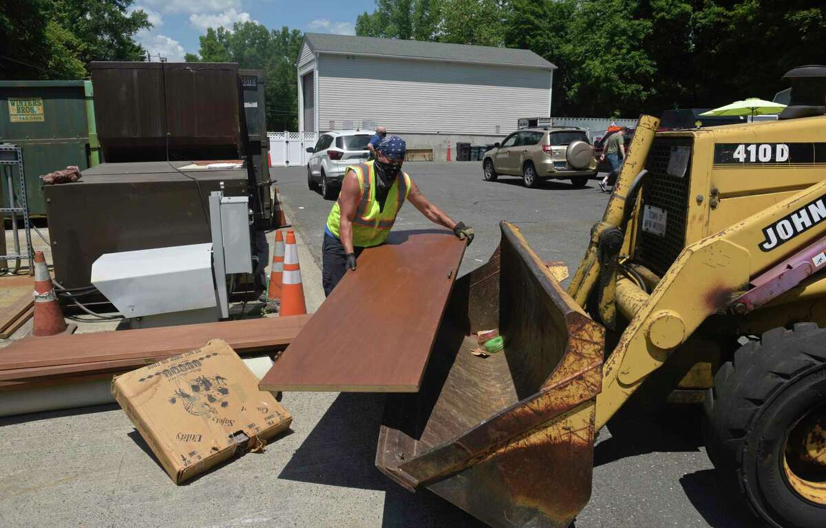 Sean Scozzafava, public works department, loads material to be recycled at the New Milford Recycling Center on June 26 in New Milford.